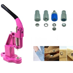 May include: A pink metal snap button press machine with a black handle. The machine is used to attach snap buttons to fabric. The image also shows a set of snap button dies, a variety of snap buttons, and examples of the buttons attached to fabric.