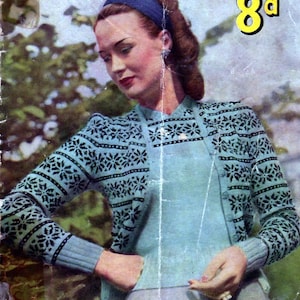 May include: A vintage magazine cover featuring a woman wearing a blue and black Fair Isle knit cardigan. The magazine is titled "Stitchcraft" and the price is listed as "8d". The text "Fashions in Fair Isle" is printed at the bottom of the cover.