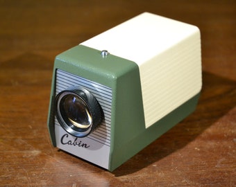 Vintage Cabin small size slide projector.  In original condition. Sixty years old and virtually as new!