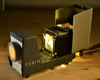 Upgraded to an LED light source. Vintage Cabin small size slide projector.