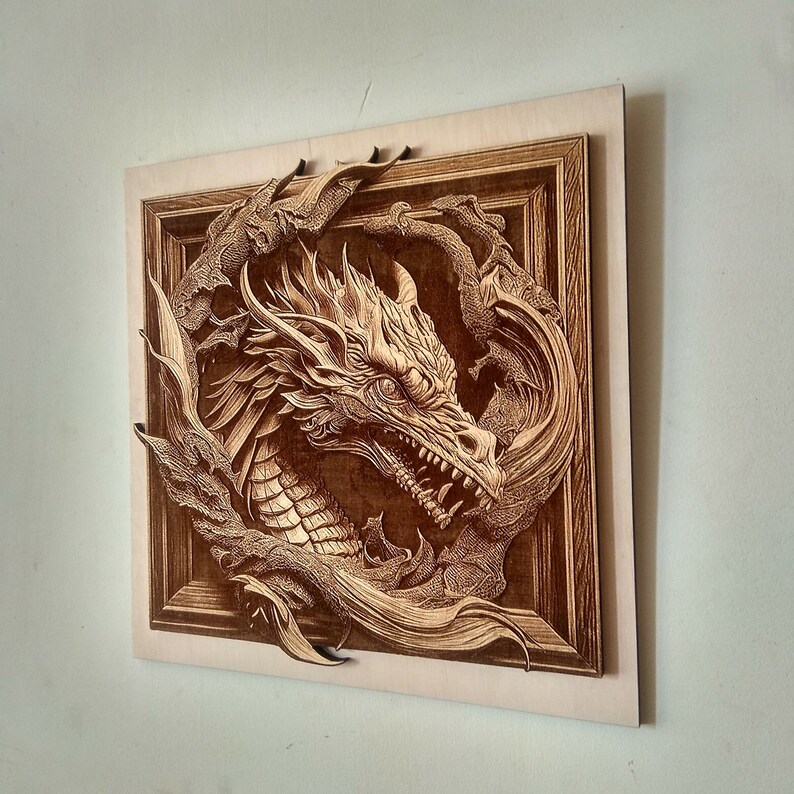 May include: A wooden wall art piece featuring a detailed carving of a dragon's head with intricate details. The dragon is framed in a wooden frame with a brown finish.