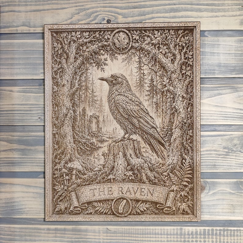 May include: A rectangular wooden plaque featuring a detailed laser-engraved illustration of a raven perched on a tree stump. The scene includes a forest background, foliage, and a banner at the bottom with the text THE RAVEN and a feather icon.
