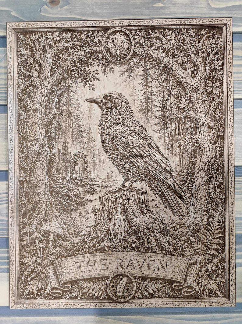 May include: A rectangular wooden wall art piece featuring a detailed brown-toned engraving of a raven perched on a tree stump. The scene includes a forest, stone ruins, and mushrooms. A banner at the bottom displays the text THE RAVEN with a feather icon.