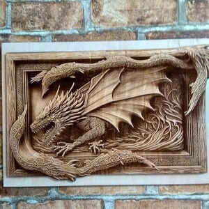 May include: A wooden wall art carving of a dragon with its wings spread wide. The dragon is carved in detail and has a fierce expression. The carving is set in a wooden frame.