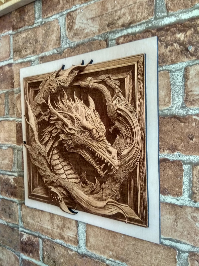 May include: A wooden wall art piece featuring a detailed carving of a dragon's head emerging from a frame. The dragon is carved in a 3D style, with its scales and wings appearing to come out of the wood.