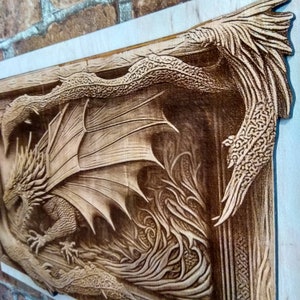 May include: A wooden carving of a dragon with its wings spread wide. The dragon is carved in a detailed style, with scales and claws visible. The carving is set against a background of flames.