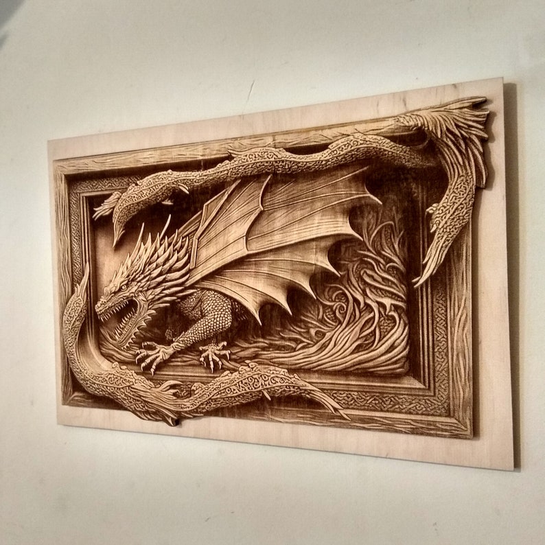 May include: A wooden wall art sculpture of a dragon with its wings spread wide. The dragon is carved in intricate detail and is surrounded by a frame of swirling vines.