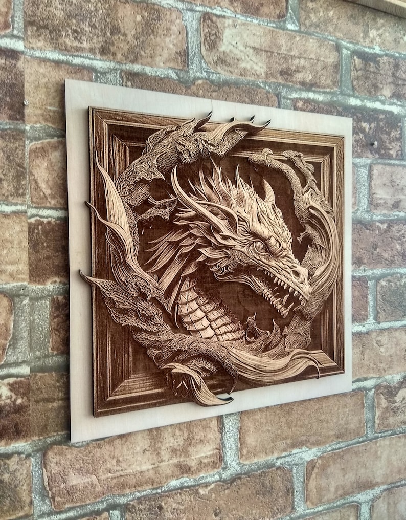 May include: A wooden wall art piece featuring a detailed carving of a dragon's head emerging from a swirling pattern. The dragon is carved in a light brown wood and has a fierce expression.
