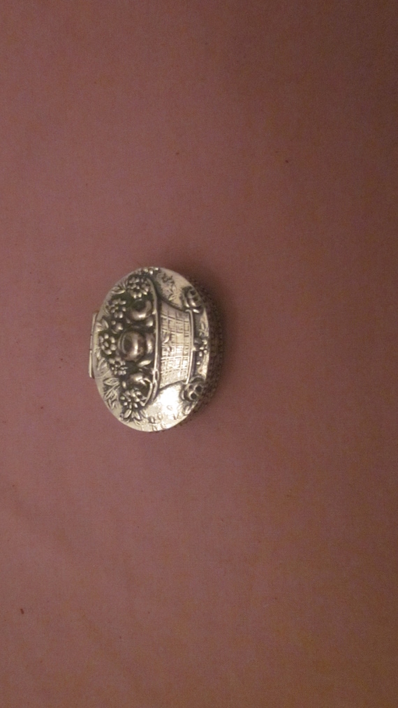 a Coin Silver [.800] Repousse Pill Box, hinged top