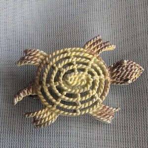 May include: A white ceramic mug with a black handle and the text "But First, Coffee" in a handwritten style. The mug is on a white surface. The mug is approximately 4 inches tall.