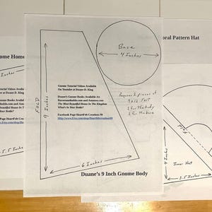 May include: Three white paper patterns for gnome crafts. The patterns include measurements in inches for the gnome body, hat, and home. The text includes instructions and a Facebook page link.
