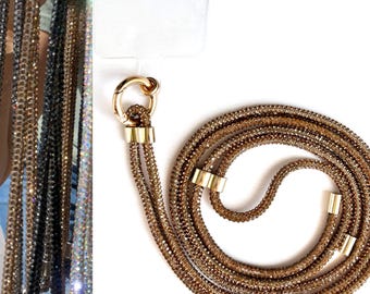 May include: A gold-toned chain necklace with a sparkly, crystal-like finish. The chain is made of multiple strands and has a gold-toned clasp.