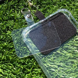 May include: A clear phone case with a black adhesive pad on the back. The case is attached to a black lanyard with a silver clasp.