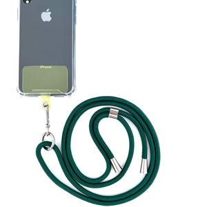 Może przedstawiać: Przezroczyste etui na telefon z zielonym paskiem na telefon. Na etui widnieje napis "iPhone".