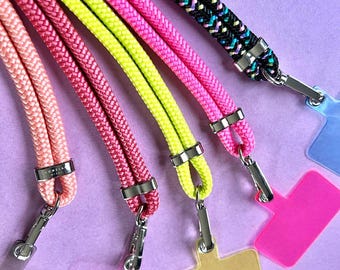 May include: Five colorful lanyards with silver clasps and matching plastic badge holders. The lanyards are pink, yellow, green, pink, and black with white stripes.