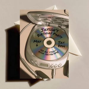 May include: A birthday party invitation featuring a CD inside a portable CD player. The CD has handwritten text: "Jayson's Birthday Party, May 6, Sat. 8PM, 123 Any Street, RSVP: 123.456.7890". Headphones are visible.