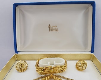 Vintage 1955-1969 Crown Trifari jewelry set with Original box. Starburst Gold tone pendant necklace with clip earrings and 7" Bracelet.