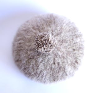 May include: A set of three ceramic mugs with a speckled, cream-colored glaze. Each mug features a different hand-painted floral design in shades of blue, green, and yellow. The mugs have a simple, rounded shape and a comfortable handle.