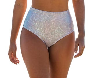 May include: High-waisted, iridescent bikini bottoms. The bottoms have a textured, dotted pattern and a pearlescent sheen. The fabric appears to be a light color, reflecting shades of silver, white, and pale blue.