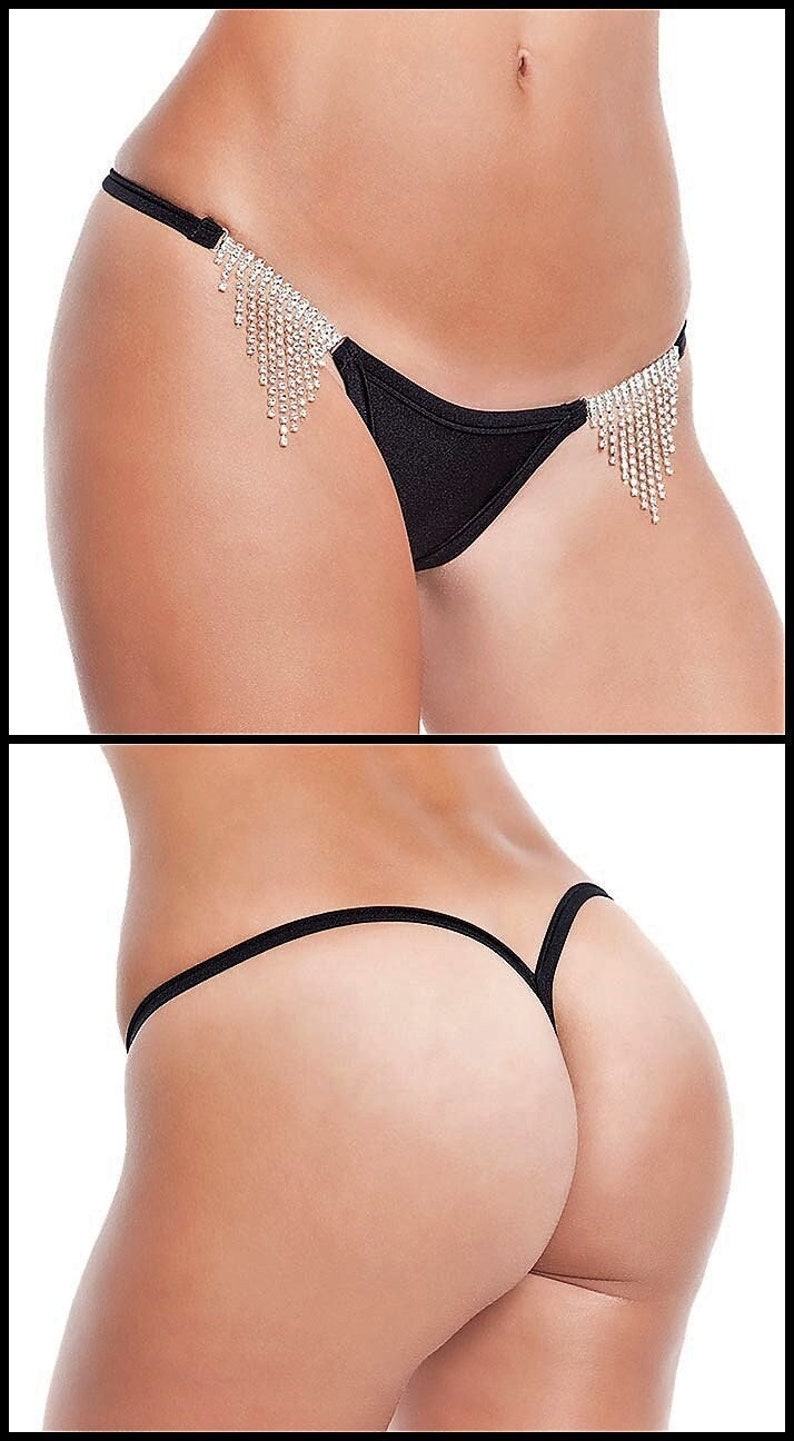 May include: Black lingerie with a thin strap and a dangling rhinestone embellishment.
