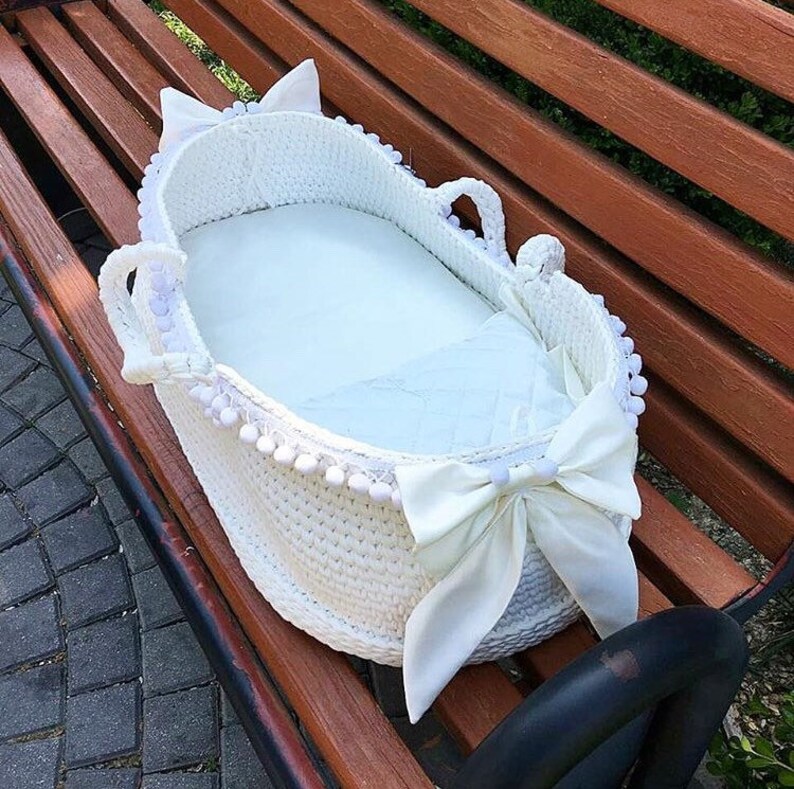 baby sleeping in moses basket