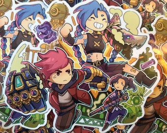 May include: A collection of colorful cartoon stickers featuring characters from the video game League of Legends. The stickers feature characters like Jinx, Vi, and Powder. The stickers are printed on white paper and have a glossy finish.