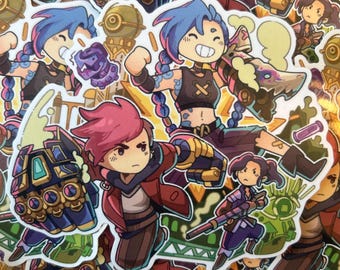 Op de afbeelding: Een verzameling gestanste vinylstickers met cartoonachtige illustraties van personages uit de animatieserie Arcane, waaronder Jinx met haar blauwe vlechten en Vi met haar grote mechanische handschoenen, weergegeven in levendige kleuren.