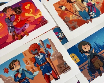 May include: A collection of rectangular art prints featuring stylized cartoon illustrations of characters in various settings, including a couple embracing, two figures walking with a brush, a blue-skinned warrior with a spear, and a dark-haired figure.