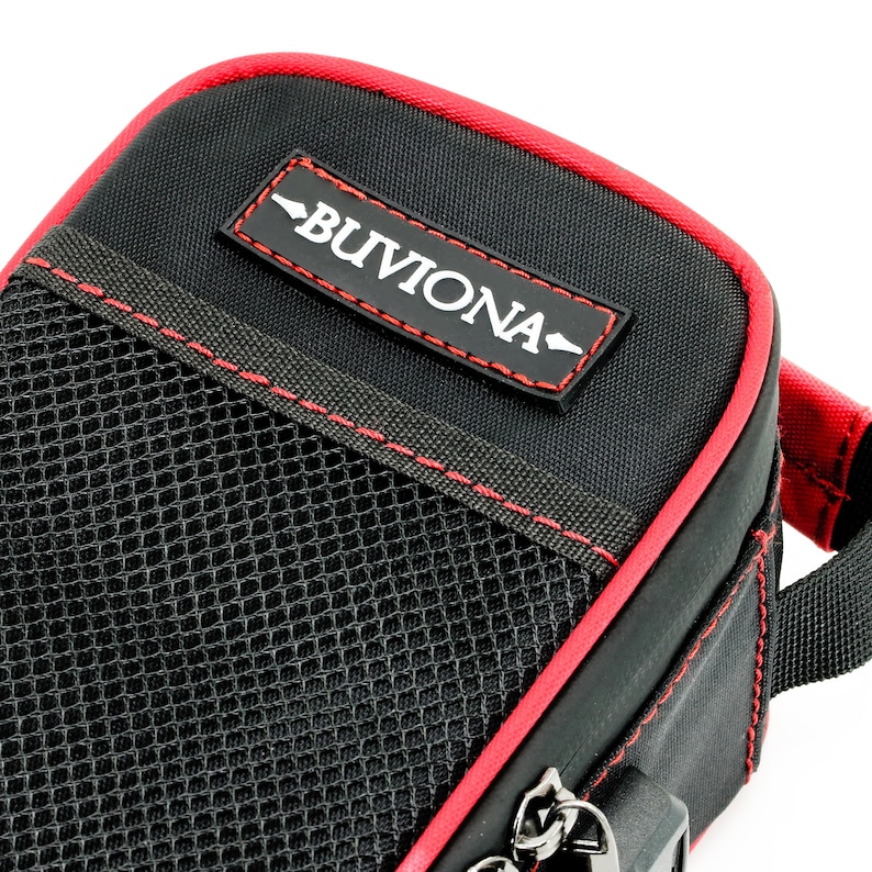 May include: Black zippered pouch with a red trim and a mesh pocket. The pouch has a red label with the text "BUVIONA" in white.