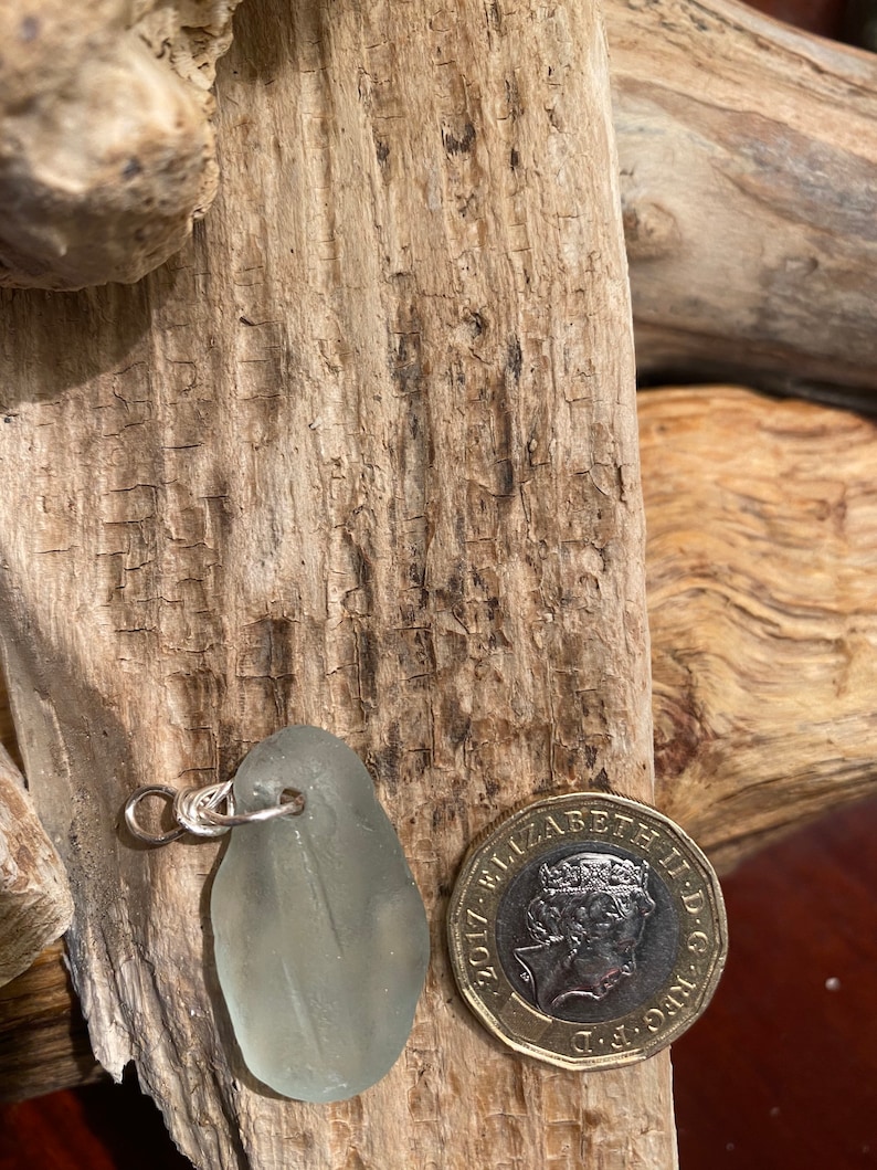 Clear Sea Glass Pendant hand wrapped in silver plate wire.