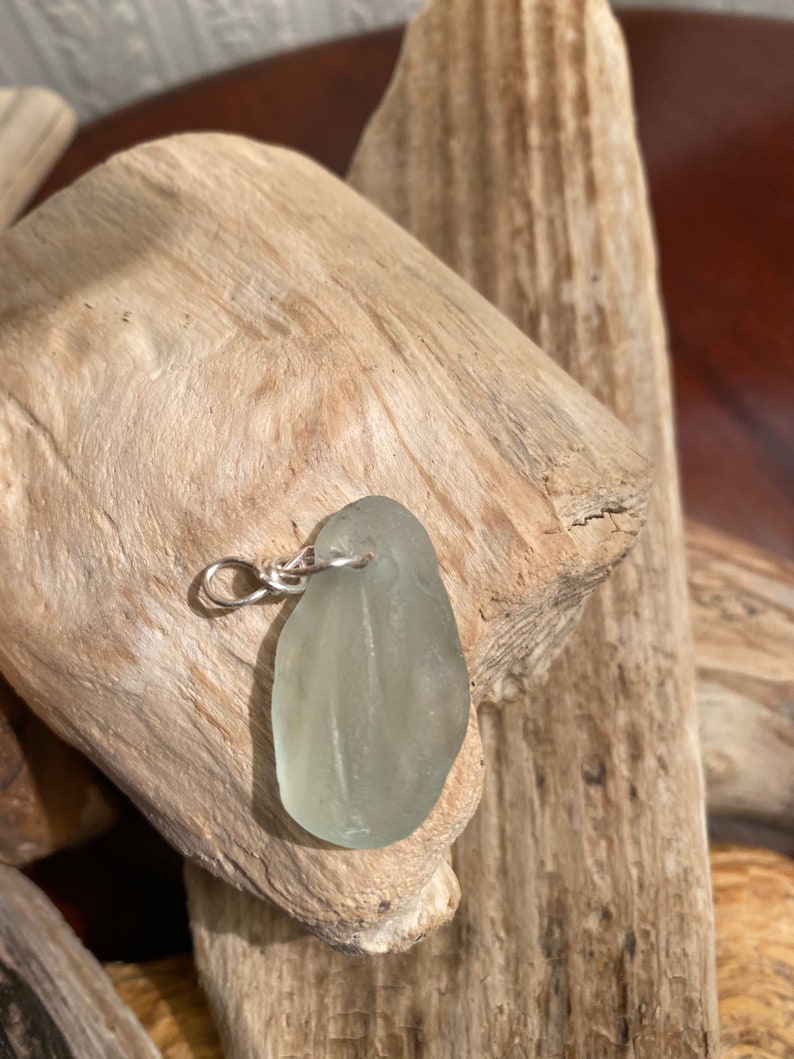 Clear Sea Glass Pendant hand wrapped in silver plate wire.