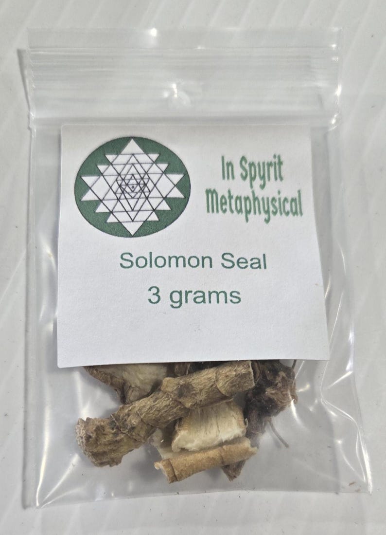 A close-up, centered shot of a single 3-gram bag of Solomon's Seal Root from InSpyrit Metaphysical. The clear packaging shows the dried, tan botanical pieces inside, and the white label prominently displays the shop's green sacred geometry logo and "3 grams