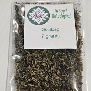 A clear plastic ritual bag containing 7 grams of dried organic Skullcap Leaf from In Spyrit Metaphysical, featuring the shop's logo and clearly labeled with the weight.