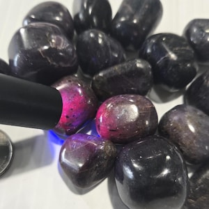 Könnte beinhalten: Eine weiße Keramik-Tasse mit schwarzem Henkel und dem Text "But First, Coffee" in schwarzer, handschriftlicher Schrift. Die Tasse steht auf einer weißen Oberfläche.