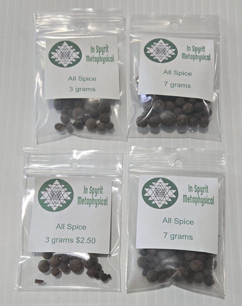 Four small, clear bags of Allspice Berries from InSpryitMetaphysical arranged on a white surface. Two bags contain 3 grams and two bags contain 7 grams of whole, dark brown dried berries. The white circular labels feature the green and black shop logo and the product weight.