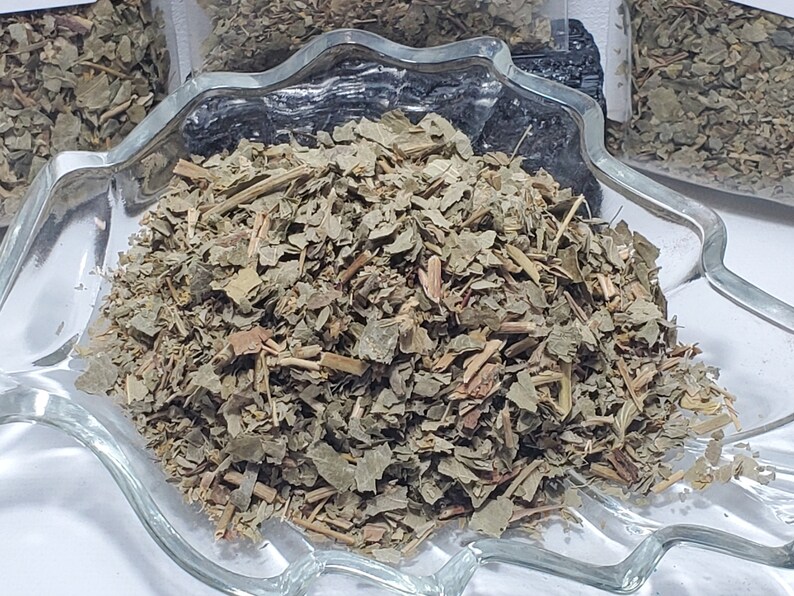 Dried Lady's Mantle herb showcased in a decorative leaf-shaped glass bowl, highlighting the high-quality cut and sifted botanical texture for spiritual and ritual use. InSpyritMetaphysical.