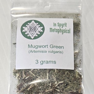 Close-up of a clear resealable bag containing 3 grams of dried Mugwort Green (Artemisia vulgaris). The white label features the InSpyrit Metaphysical star logo and the botanical name, showing the silver-green texture of the ritual herb.