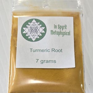 Close-up of a 7 gram bag of InSpyrit Metaphysical Turmeric Powder, showing the vibrant golden-yellow ground root and the professional white branded label.