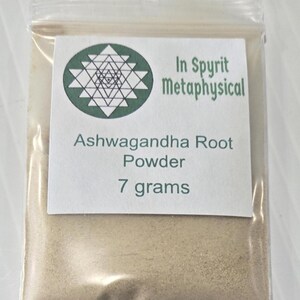 A clear bag containing 7 grams of Ashwagandha Root Powder from InSpyrit Metaphysical. The label features the sacred geometry logo and product details, showcasing the fine, tan-colored herbal powder used for grounding and vitality rituals.