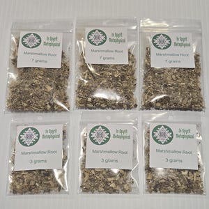 May include: Six clear plastic bags filled with dried marshmallow root. Each bag has a white label with green text that reads "In Spyrit Metaphysical" and "Marshmallow Root". Three bags contain 7 grams, and three contain 3 grams.