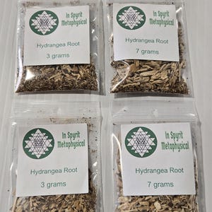 A product display photograph from InSpyrit Metaphysical showing four clear plastic bags of dried hydrangea root arranged in a grid, featuring two 3-gram sample bags on the left and two 7-gram standard bags on the right, all labeled with company branding.