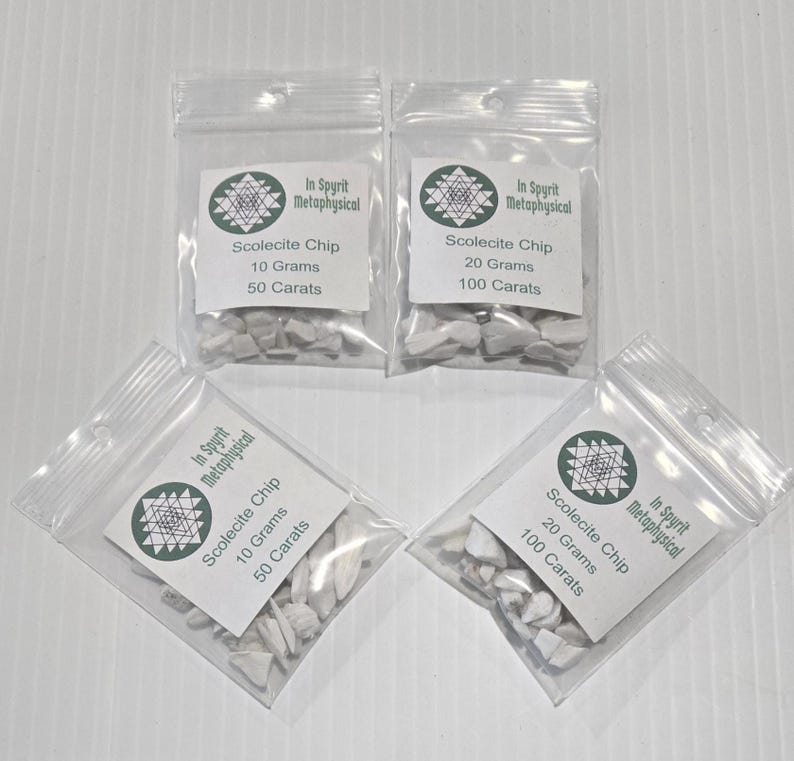 Four small, clear resealable bags filled with white Scolecite chip stones. Two bags are labeled "Scolecite Chip 10 Grams 50 Carats" and two are labeled "Scolecite Chip 20 Grams 100 Carats," all featuring the InSpyrit Metaphysical logo