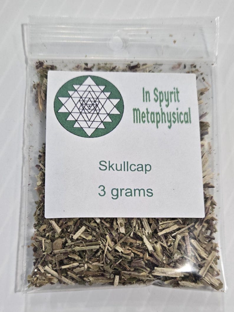 A single clear plastic ritual bag containing dried organic Skullcap Leaf from In Spyrit Metaphysical, featuring the shop's logo and clearly labeled as 3 grams.
