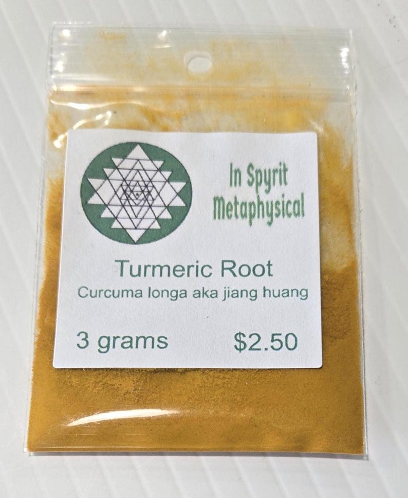 Close-up of a 3 gram bag of InSpyrit Metaphysical Turmeric Powder, showing the fine, vibrant golden-yellow texture of the ground root and the professional white branded label.