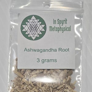 A small clear bag of dried Ashwagandha Root from In Spryit Metaphysical, clearly labeled as 3 grams, showing the natural woody texture of the sacred herb