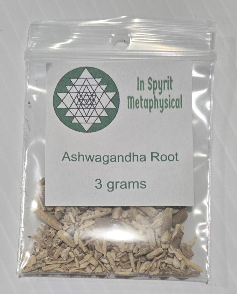 A small clear bag of dried Ashwagandha Root from In Spryit Metaphysical, clearly labeled as 3 grams, showing the natural woody texture of the sacred herb