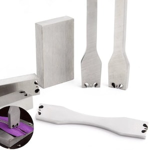 May include: A selection of stainless steel leathercraft tools, including rectangular blocks and various shaped punches. One tool is shown in use on a purple zip. The tools are designed for precision leatherworking and crafting.
