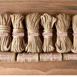 May include: Bundles of natural jute twine and rope in various thicknesses, ranging from 1mm to 12mm. The image displays several coils of rope and twine, with the size of each clearly labeled in millimeters.