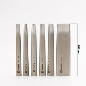 May include: A set of six silver metal leathercraft tools. The tools are labelled with sizes and the brand name "Bangbang". The largest tool is 100mm in height. The tools are used for leather working.