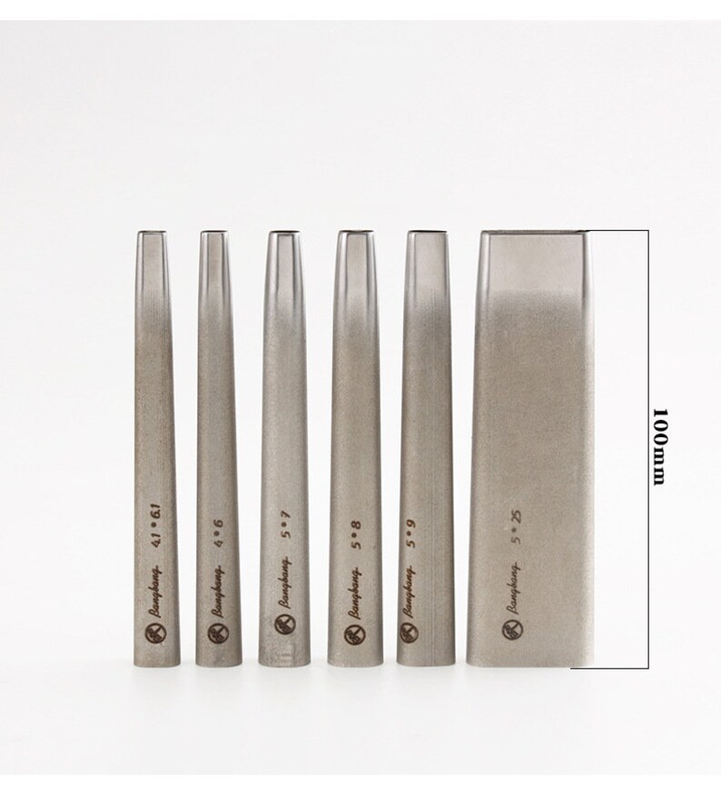 May include: A set of six silver metal leathercraft tools. The tools are labelled with sizes and the brand name "Bangbang". The largest tool is 100mm in height. The tools are used for leather working.